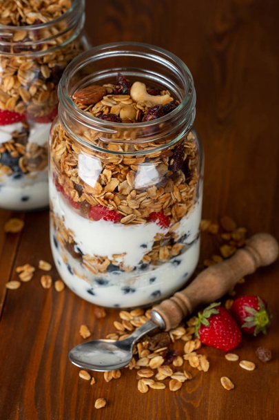 homemade granola with berries in glass jars - 写真・画像