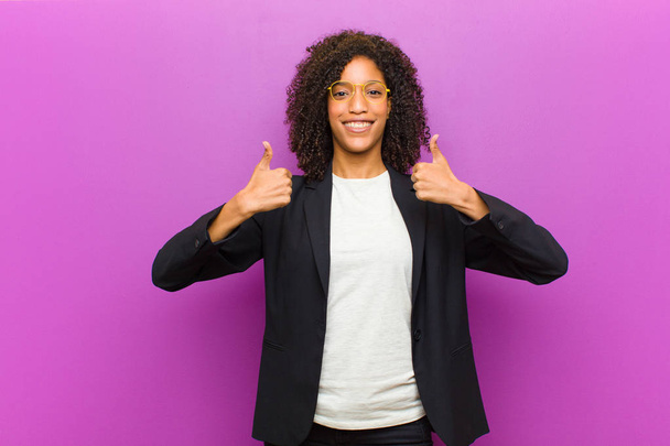 young black business woman smiling broadly looking happy, positive, confident and successful, with both thumbs up - Foto, immagini