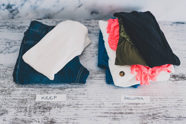 declutter and tidying up fashion clothes stacked into Keep and D - 写真・画像