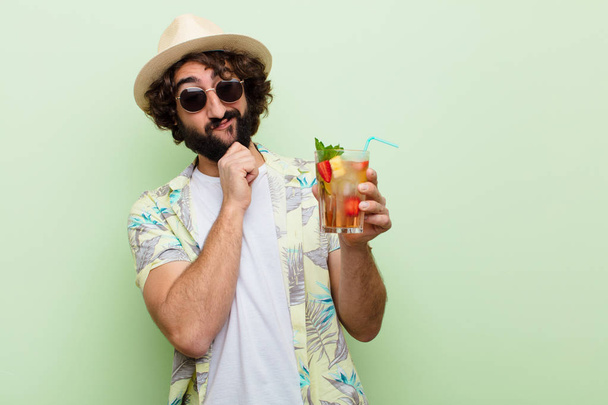young crazy bearded man with a cocktail. tourist concept - Foto, afbeelding
