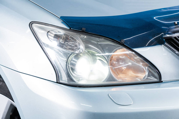 Close up of the car headlights. Exterior detail. Close up detail on one of the LED headlights modern car - Photo, Image