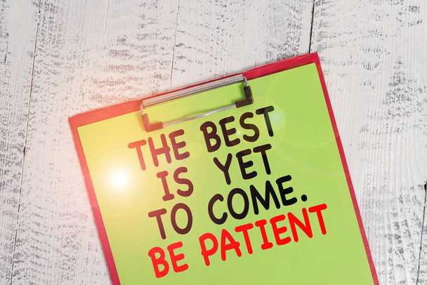 Word writing text The Best Is Yet To Come Be Patient. Business concept for dont lose hope light come after darkness Colored clipboard blank paper sheet old retro wooden vintage background. - Photo, image