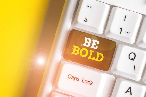Text sign showing Be Bold. Conceptual photo Go for it Fix it yourself instead of just talking Tough Hard White pc keyboard with empty note paper above white background key copy space. - Photo, Image