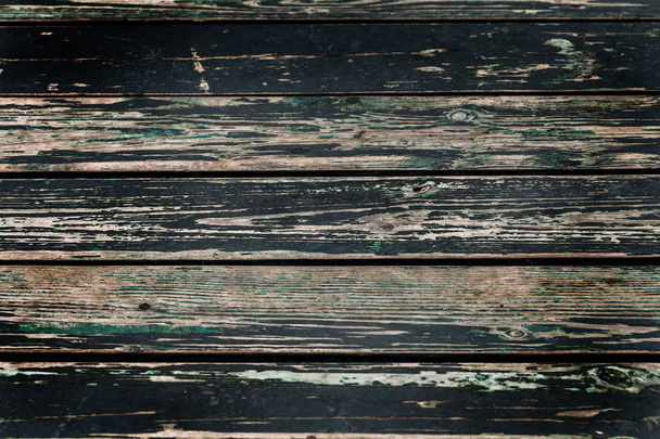 Old shabby wooden boards with cracked paint, background. Background old wood with large cracks and traces of the remains of old paint - Фото, зображення