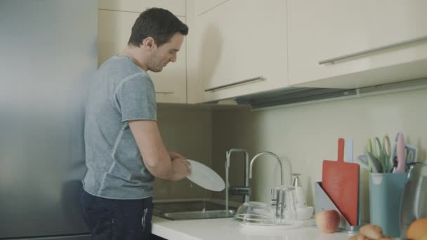 Cheerful husband doing household chores in slow motion. - Footage, Video