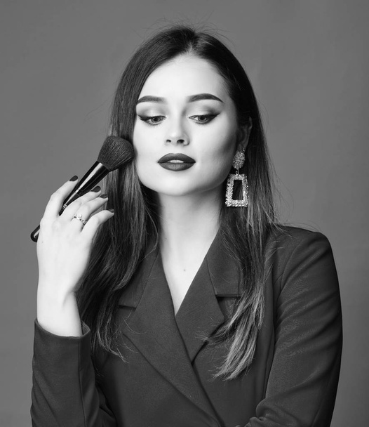 Hiding all imperfections. Perfect skin tone. Makeup artist concept. Looking good and feeling confident. Gorgeous lady makeup red lips. Fashion model tv host. Attractive woman applying makeup brush - Foto, Bild
