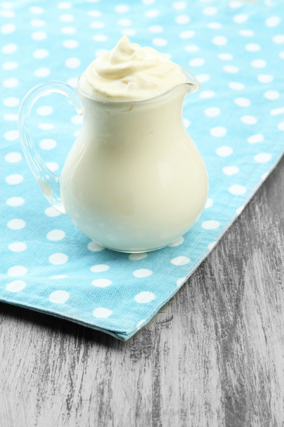Sour cream in pitcher on table close-up - Φωτογραφία, εικόνα