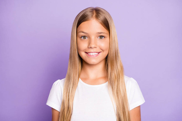 Close up photo of pretty positive cheerful child look have fun free time holidays with her family friends wear white t-shirt clothe isolated over violet color background - Фото, зображення
