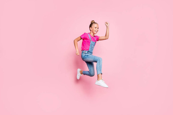 Turned full length body size side profile photo of cheerful cute nice funky girl running towards sales discount at shopping mall wearing jeans denim t-shirt isolated over pastel color background - Фото, изображение