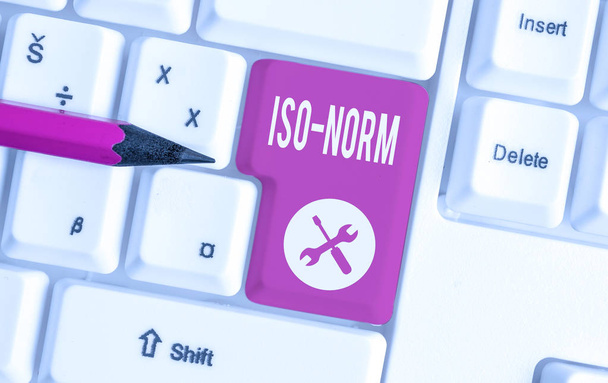 Text sign showing Iso Norm. Conceptual photo An accepted standard or a way of doing things most showing agreed White pc keyboard with empty note paper above white background key copy space. - Photo, Image