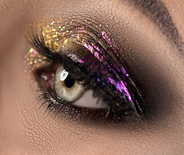 Beautiful eye makeup with colorful sparks. Beauty bright fashion - Fotografie, Obrázek