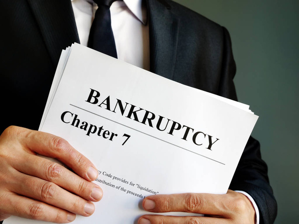 Bankruptcy Chapter 7 documents in the hands. - Photo, Image