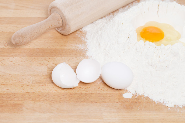 yolk in flour with a rolling pin - Фото, изображение