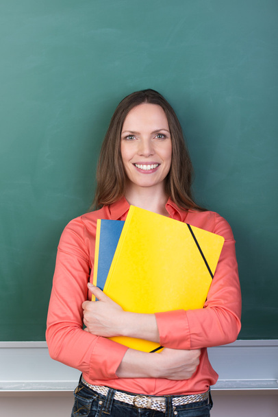 Friendly student or teacher clutching a her files - Photo, Image