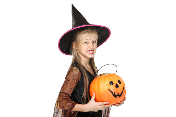 Young girl in halloween costume holding pumpkin bucket with cand - Fotoğraf, Görsel