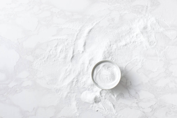 Baking soda in a bowl on the marble countertop - Photo, Image