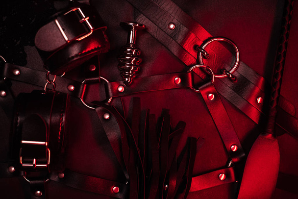 Set for BDSM sex in a shop of leather accessories and metal anal plugs - Foto, Imagen