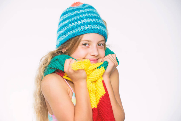 Kid wear warm soft knitted blue hat and long scarf. Warm woolen accessories. Hat and scarf keep warm. Which fabrics will keep you warmest this winter. Girl long hair happy face white background - Foto, Imagen