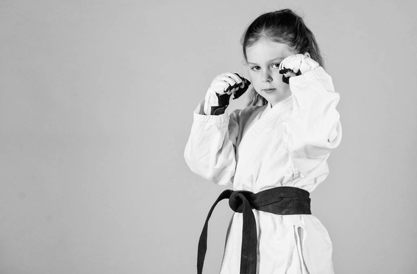 knockout. energy and activity for kids. practicing Kung Fu. happy childhood. sport success in single combat. girl in martial arts uniform. little girl in gi sportswear. copy space. Ready to fight - Photo, Image