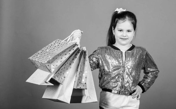 Great choices. Girl with shopping bags violet background. Shopping and purchase. Black friday. Sale discount. Shopping day. Child hold bunch packages. Kids fashion. Surprise gift. Great stores - Φωτογραφία, εικόνα