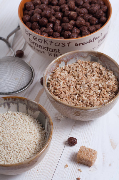 Flakes, sugar, seeds semi-cook for porridge close up in white key - Photo, image