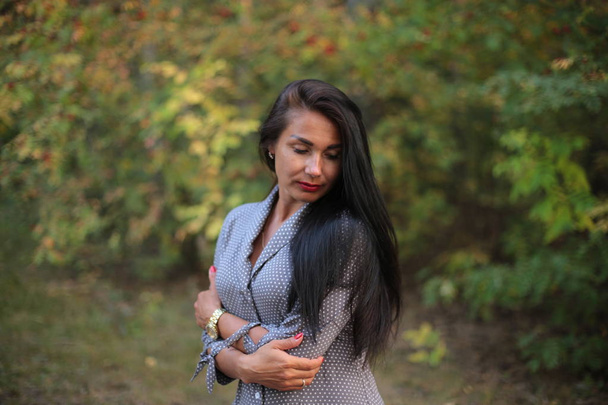 portrait of a girl with long black hair on an autumn walk - Photo, Image