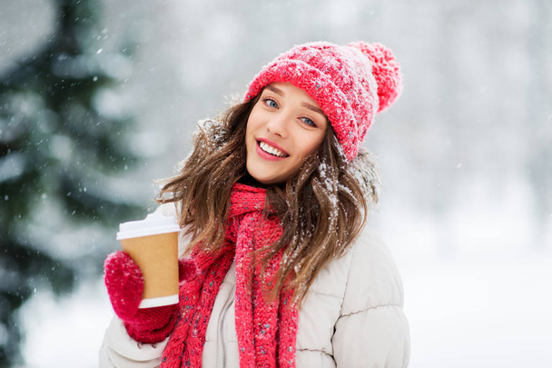 happy teenage girl with coffee in winter park - Fotó, kép