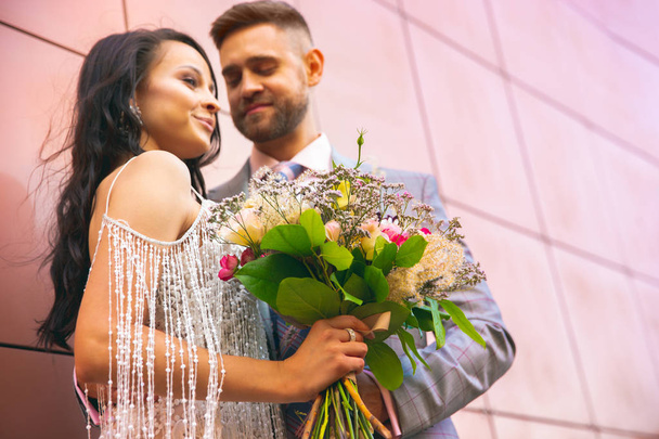 Caucasian romantic young couple celebrating their marriage in city - 写真・画像