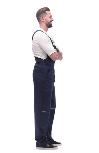 side view. smiling man in overalls looking forward to copy space - Photo, Image