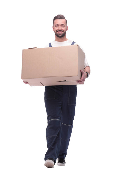 in full growth. smiling man carries a large cardboard box - Фото, изображение