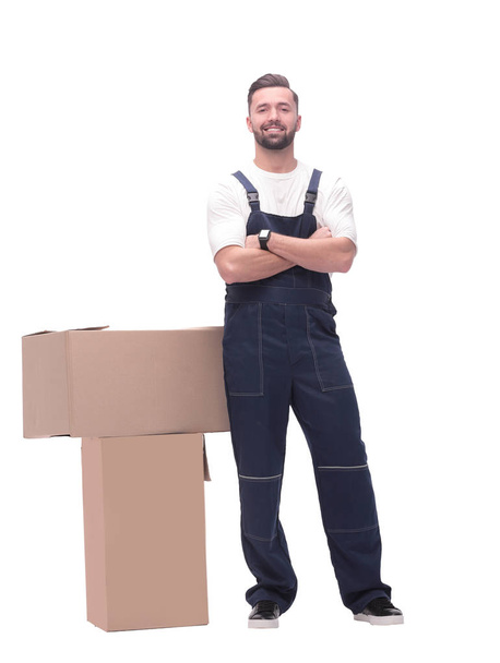 in full growth. smiling man standing near cardboard boxes - 写真・画像