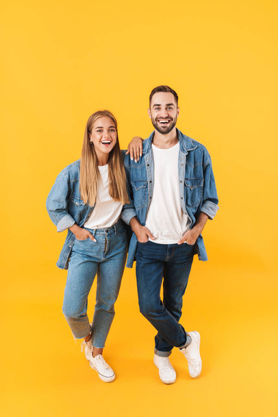 Full length image of caucasian couple in denim clothes smiling at camera - Photo, Image
