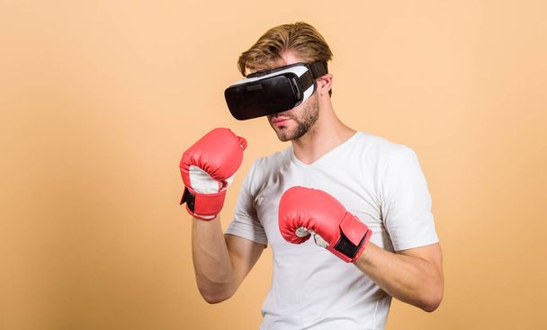 Augmented 3D world. Cyber sportsman boxing gloves. Man play game in VR glasses. Cyber sport concept. Man boxer virtual reality headset simulation. Cyber coach online training. Explore cyber space - 写真・画像