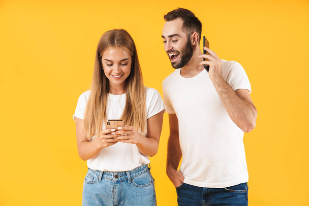 Image of happy man smiling while looking at cellphone of his girlfriend - Φωτογραφία, εικόνα