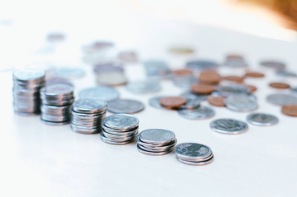 Coins stacked on blurred background and copy space - Coins scattered on white background - Economy Concept - Financial and Business Freedom. - Фото, зображення