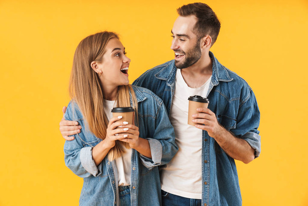 Image of content couple smiling while holding takeaway coffee cups - Fotografie, Obrázek