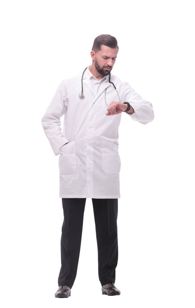 in full growth. medical doctor looking at his wrist watch - Фото, изображение