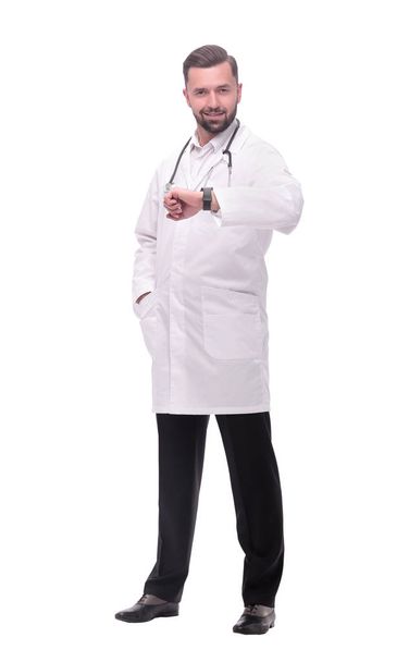 in full growth. medical doctor looking at his wrist watch - Φωτογραφία, εικόνα