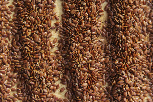 Коричневые семена льна создают фон льняного масла
 - Фото, изображение