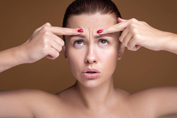 Brunette caucasian woman squeeze acne. Close up portrait of face - Fotografie, Obrázek