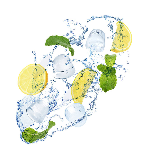 Crystal clear ice cubes, lemon, mint and splashing water on white background - Photo, image