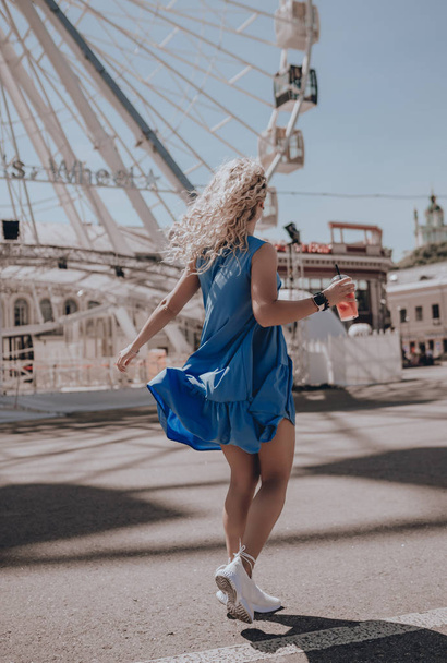Woman happy running in summer dress. Italy. Lifestyle. Girl smiling laughing joyful having fun. Walking on city street. Sundress. Fashion. Urban style - Photo, image