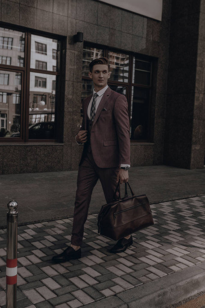 Young businessman wearing in full suit posing on city street. Business concept. Handsome manager. Success time - Zdjęcie, obraz