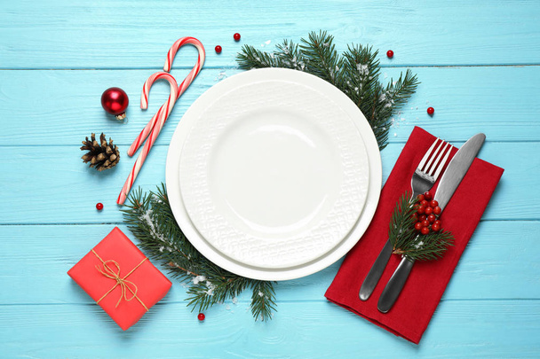 Christmas table setting on blue wooden background, top view. Space for text - Foto, imagen
