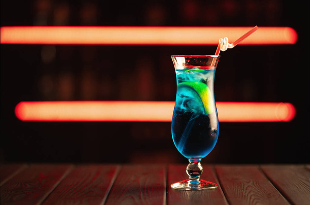 Fresh blue cocktail on a neon background. Alcoholic cocktail. Fruit Non-alcoholic cocktail. - Valokuva, kuva
