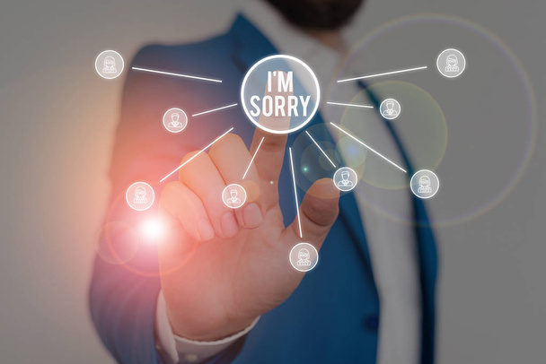 Writing note showing I M Sorry. Business photo showcasing Toask for forgiveness to someone you unintensionaly hurt Male wear formal work suit presenting presentation smart device. - Photo, Image
