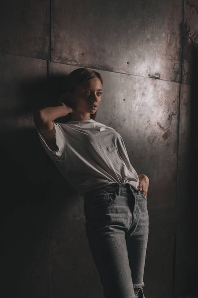 Sexy hot woman in white shirt and jeans posing in loft studio on metallic wall background. Seductive glamour young girl model portrait. - Φωτογραφία, εικόνα
