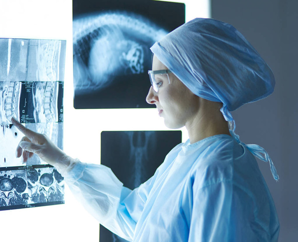 Two female women medical doctors looking at x-rays in a hospita - Фото, зображення