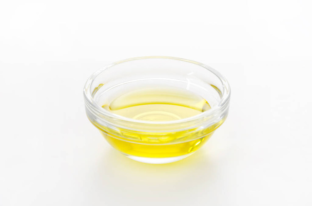 Olive oil in glass bowl  - Фото, изображение