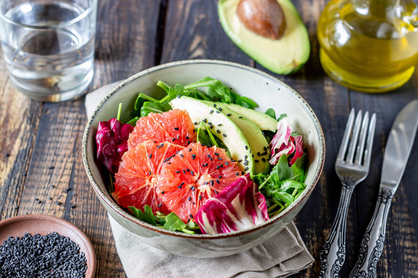 Salad with avocado and grapefruit. Healthy eating. Vegetarian food. - Photo, image